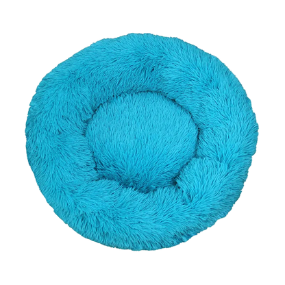 Blue fluffy pet bed on a white background