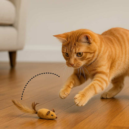 Orange tabby cat playing with a toy mouse on a wooden floor.